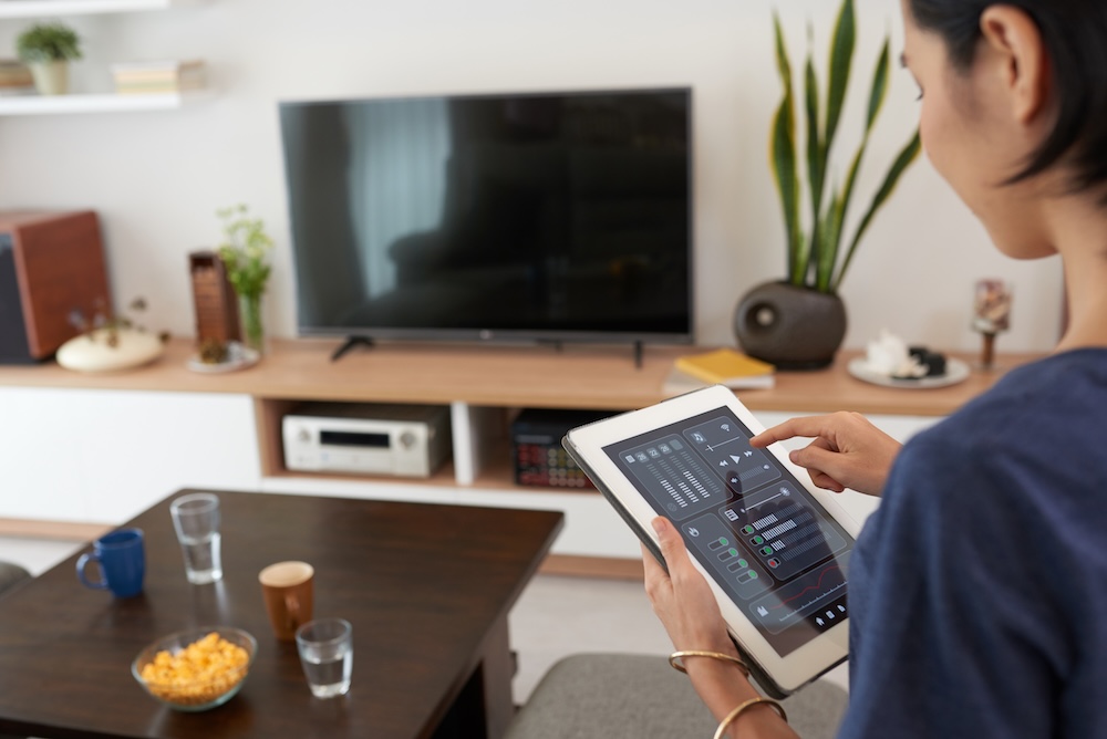 a person using her smart home remote